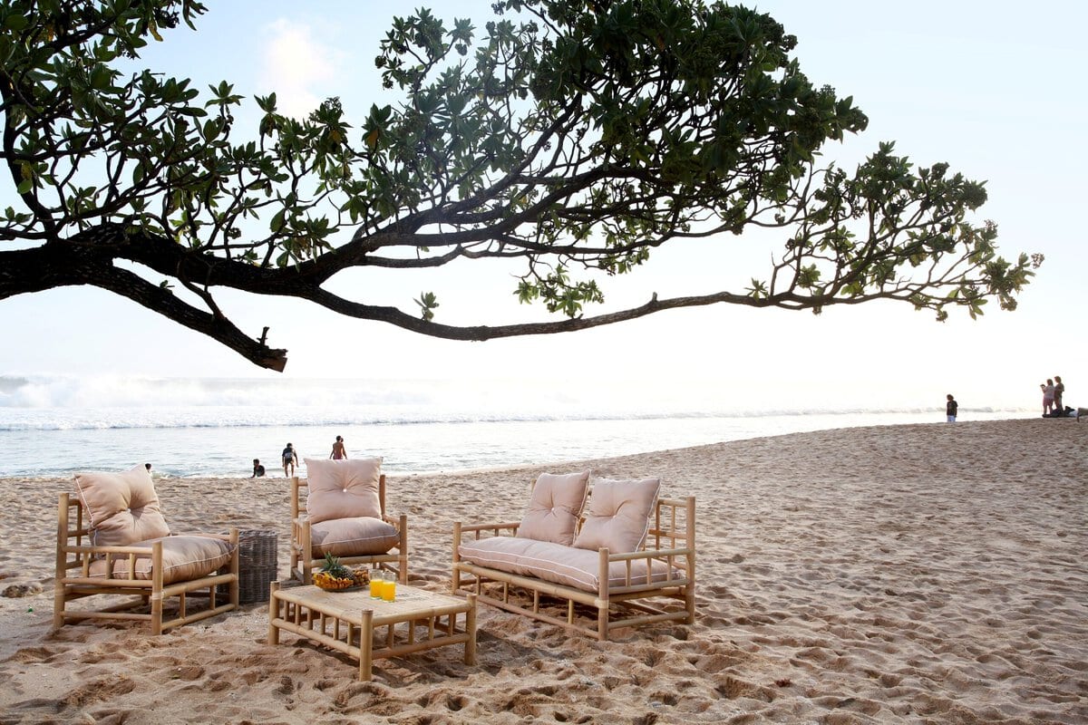 Σετ σαλόνι Madrit από φυσικό καλάμι με μαξιλάρι. Το σετ περιλαμβάνει ένα καναπέ, δύο πολυθρόνες και ένα τραπέζι. Ένα σαλόνι από μπαμπού προσφέρει οικονομικά, ελαφριά, και ανθεκτικά έπιπλα που χαρίζουν ζεστή, φυσική, και εξωτική αισθητική, ενισχύοντας παράλληλα τη βιωσιμότητα του χώρου. Επιπλέον, το μπαμπού συμβάλλει σε μια πιο χαλαρωτική ατμόσφαιρα και μπορεί να προσφέρει μια αίσθηση γαλήνης και αρμονίας. Διαστάσεις προϊόντος: Καναπές: 180x80x100, Πολυθρόνα 80x80x100, Τραπέζι 110x70x40